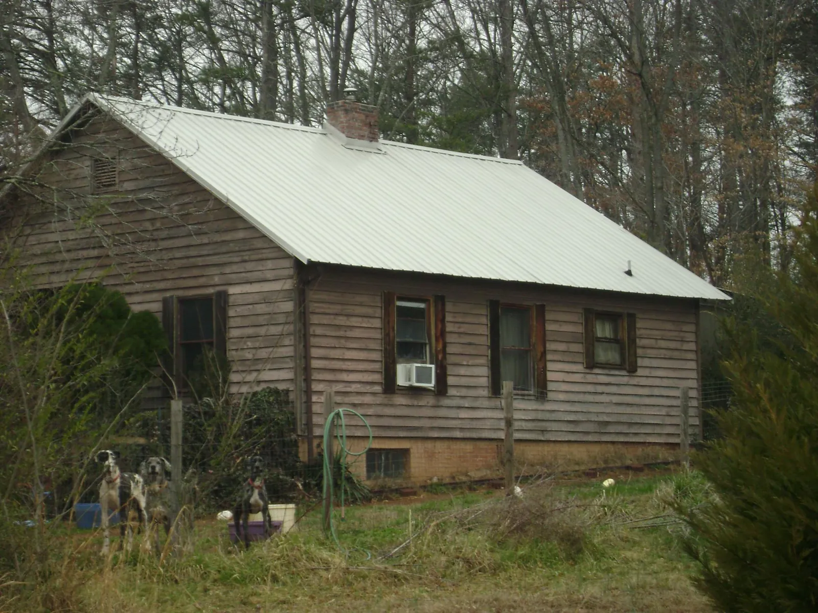 White metal roof on an old wood sided farmhouse, from a Metal Roof Installation job in Trenton